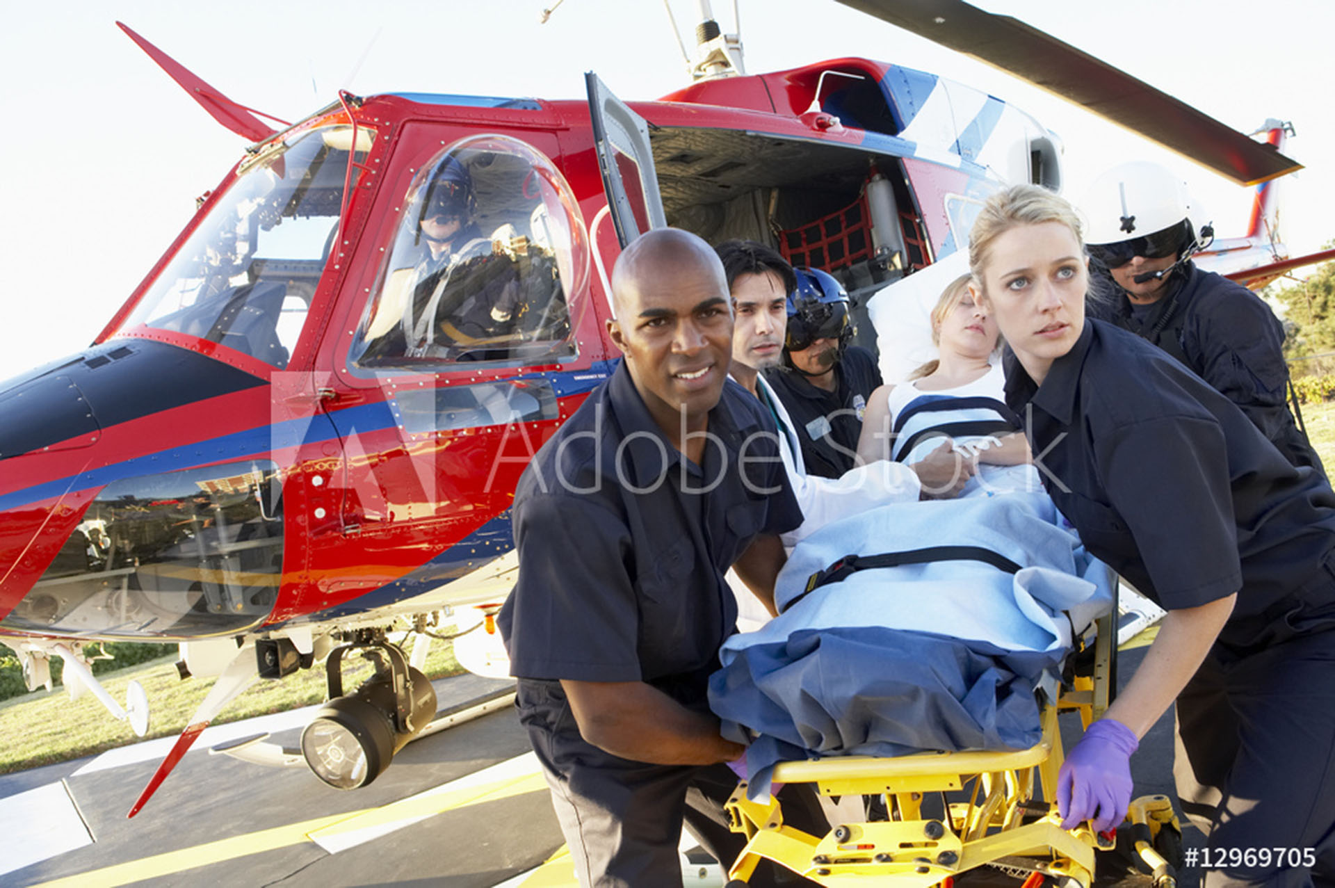 A group of people standing around an ambulance.