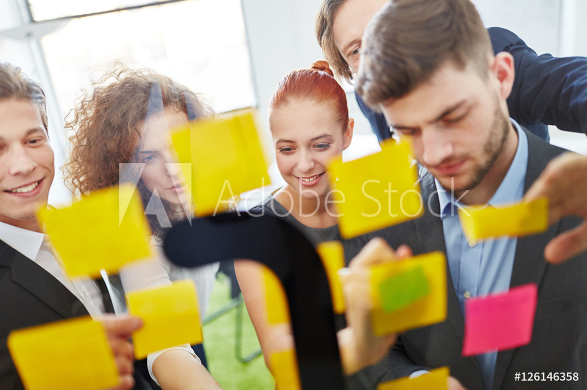 A group of people standing around each other.